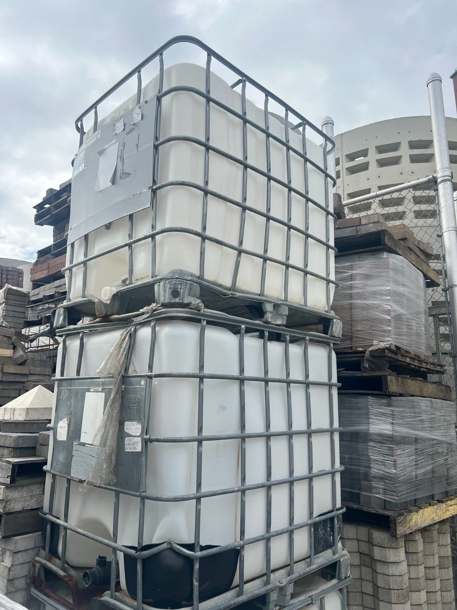 275-gallon IBC totes stacked in a storage yard